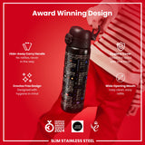 A black, slim stainless steel water bottle with a video game design is being held; it features a hide-away handle, hygiene cover, and wide mouth opening, against a red background. Award Winning Design. German Design Award Winner 2024. Good Design.