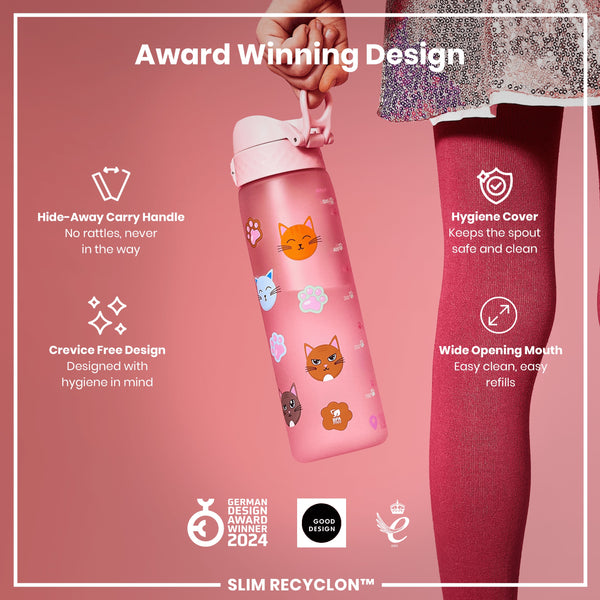A pink water bottle, featuring a cat design, is held by a hand. Its features include a hide-away handle, crevice-free design, hygiene cover, and wide opening mouth. The bottle is an award-winning design.
