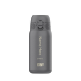 A gray water bottle with a flip-top lid stands upright against a plain background featuring vertical text 