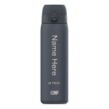 A dark-gray water bottle stands upright against a white background featuring text vertically reading 